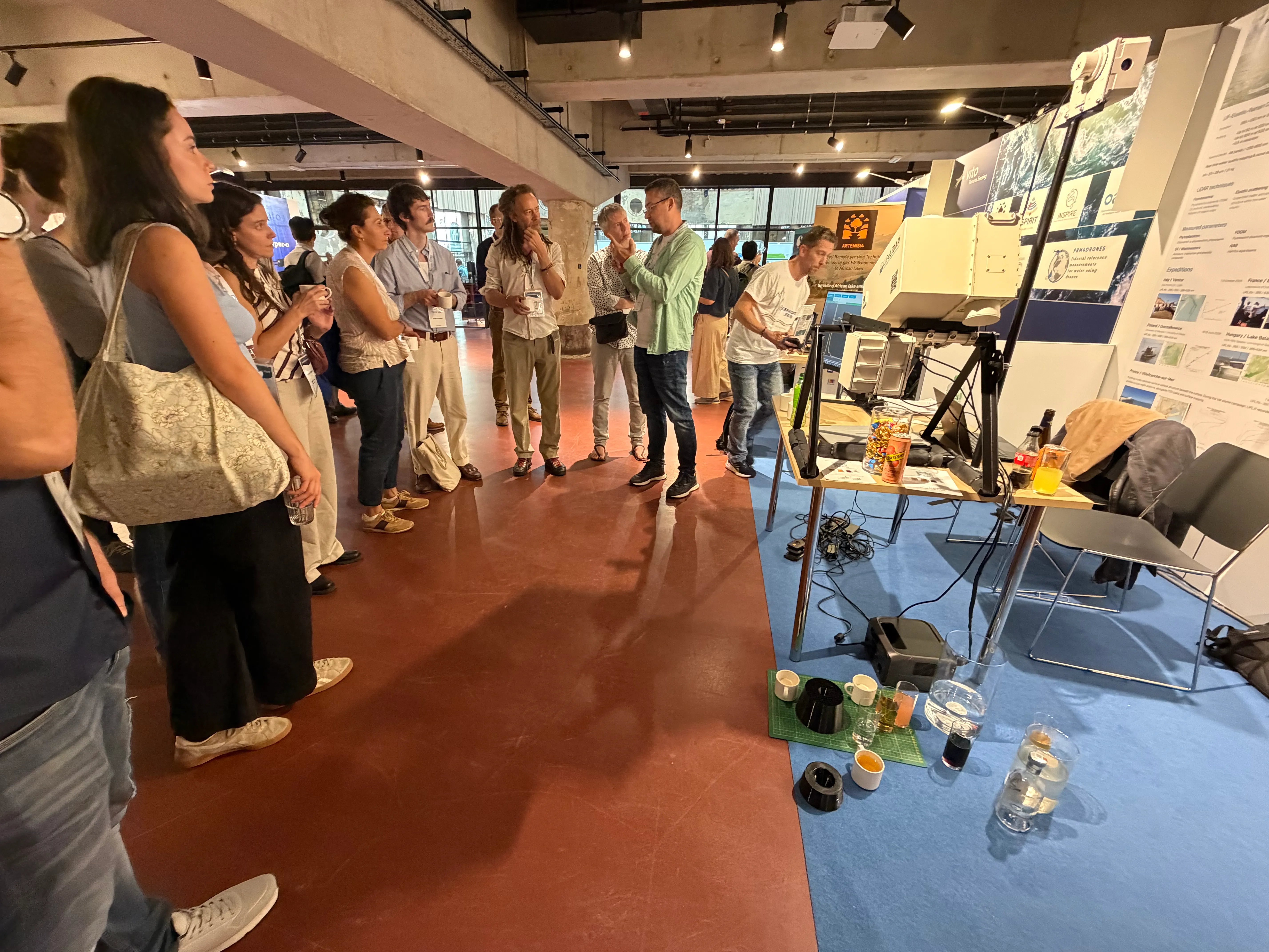Visitors watching a demonstration at the LIFeLiDAR booth at Ocean Optics Conference XXVII
