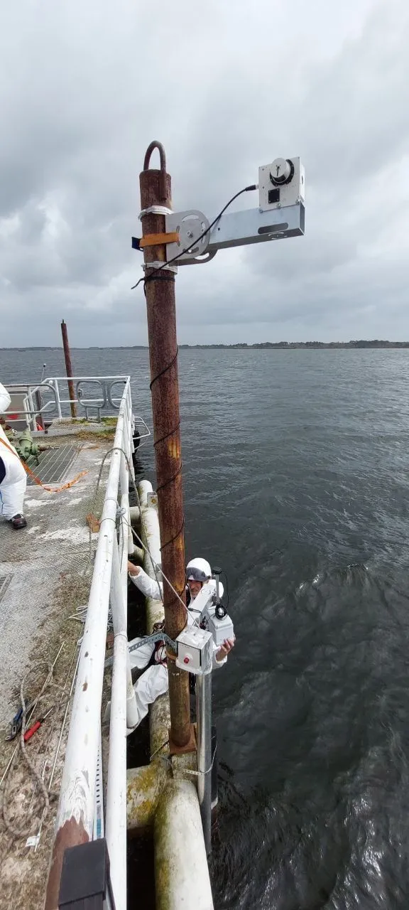 Paired optical instruments mounted above the water at Parentis Lake